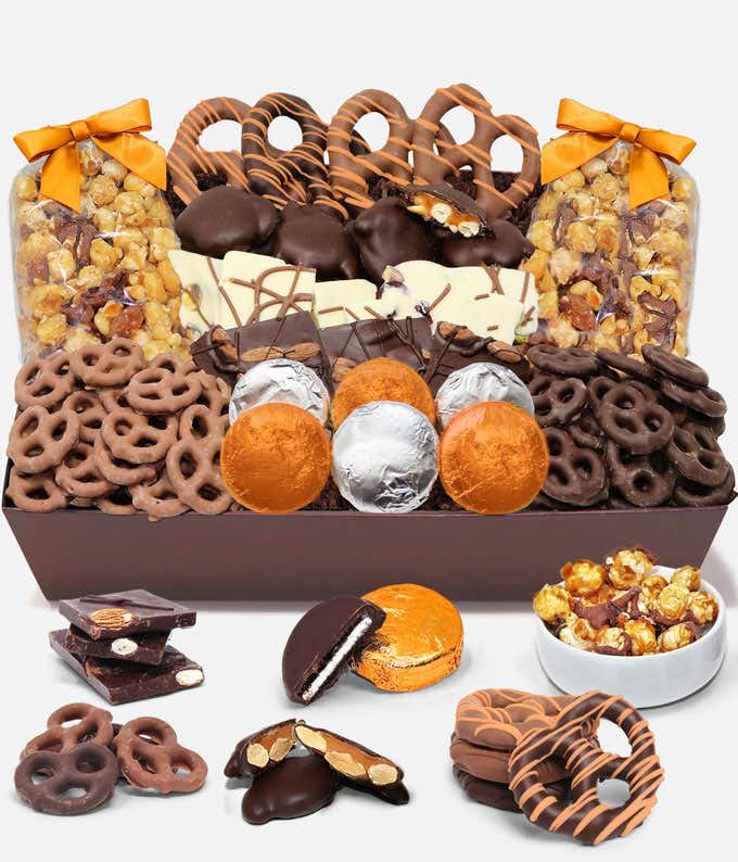 An indulgent assortment featuring 6 OREO® cookies covered in Belgian milk chocolate, Belgian milk and dark chocolate covered mini pretzels, large pretzel twists, Belgian chocolate almond and pistachio bark, caramel popcorn, and caramel cashew clusters, in