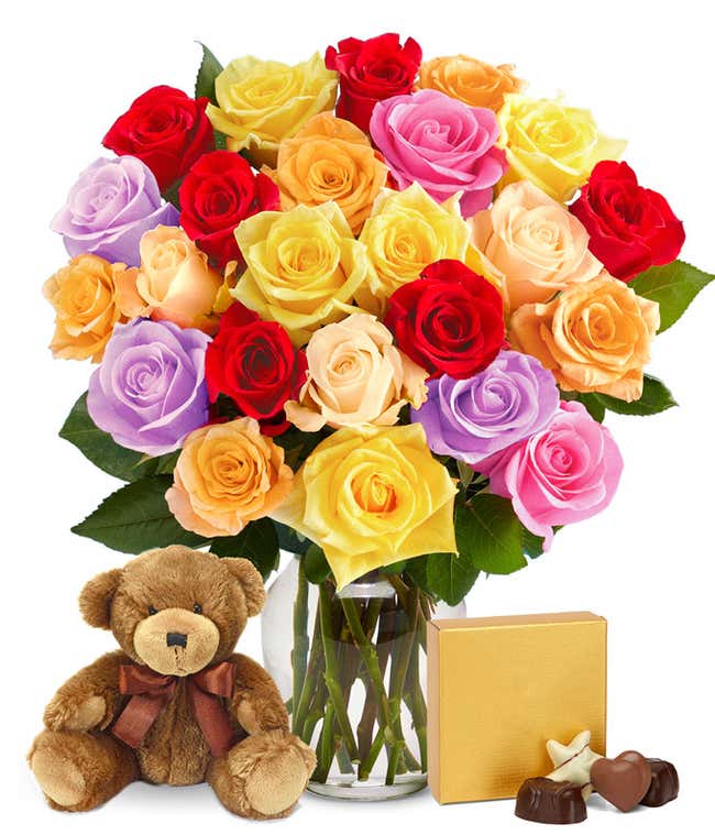 I'm sorry gift set featuring two dozen vibrant rainbow roses, a cuddly teddy bear, and a box of chocolates, with optional glass vase and personalized message. A sincere gesture to seek forgiveness with warmth and sweetness.