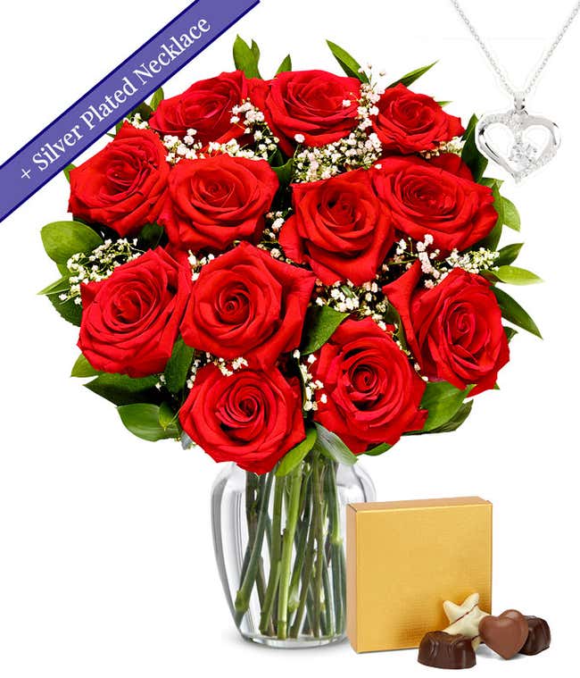 One dozen red roses with a silver heart necklace on a chain and a small box of assorted chocolates