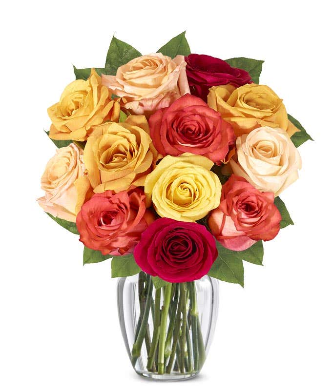 A stunning floral arrangement featuring orange roses, red roses, and yellow roses, optionally presented in a glass vase.