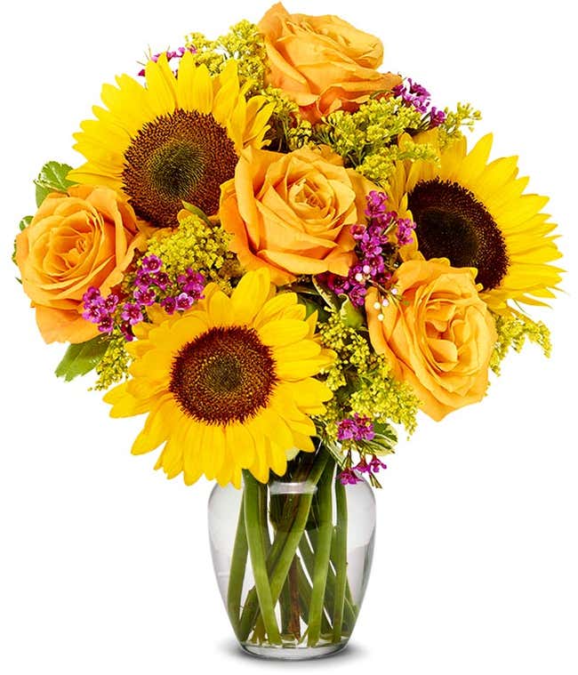  A vibrant floral arrangement featuring sunflowers, orange roses, pink wax flowers, and yellow solidago.