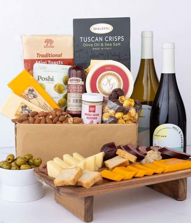 An abundant gift box filled with two bottles of California wine - red &amp; white, assorted crackers, three cheeses, summer sausage, and snacks to make an amazing charcuterie spread. 