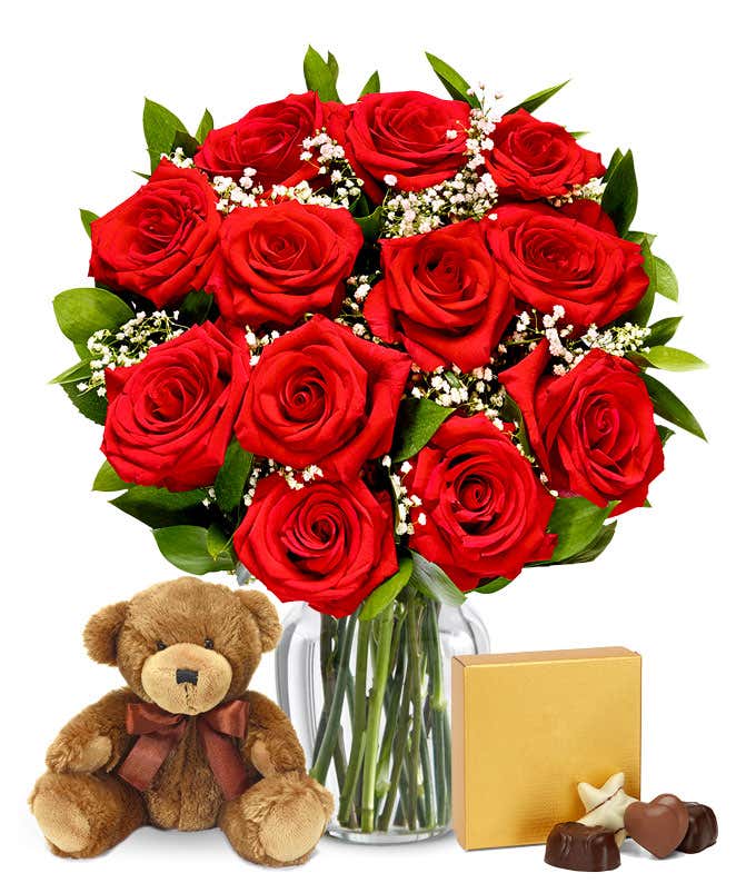 A romantic gift set featuring 12 long stem red roses, a cuddly teddy bear, and a box of chocolates, optionally presented in a vase. This classic combination offers a heartfelt and memorable display for any special occasion.