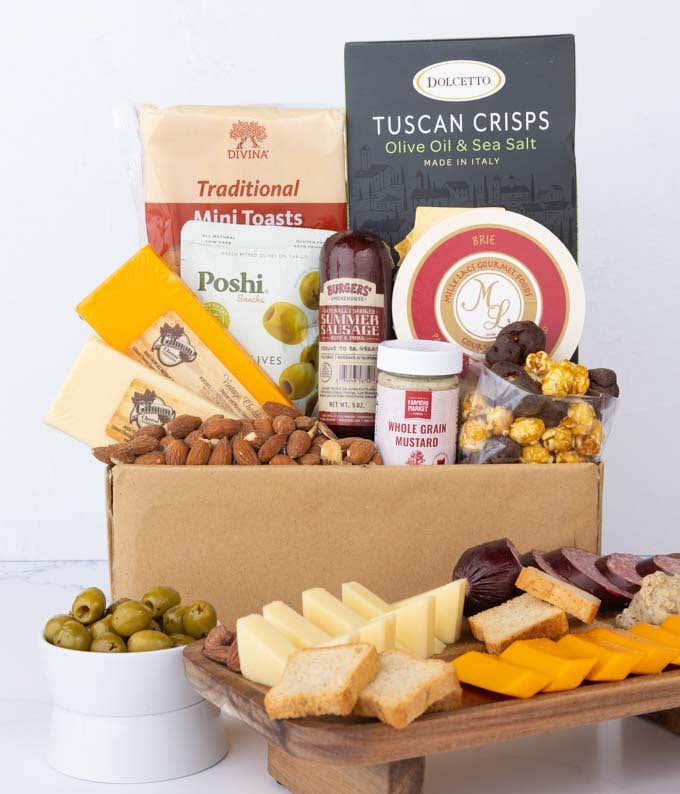 A gourmet charcuterie gift set featuring Tuscan crisps, focaccia crackers, smoked cheddar, garlic & onion cheese, brie spread, olives, mustard, almonds, chocolate-covered popcorn, and summer sausage.  Perfect for entertaining.