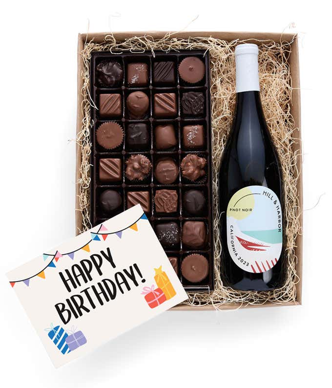 A birthday gift box containing a bottle of Hill & Harbor Pinot Noir, a 1 lb box of 28 assorted gourmet chocolates in a grid, and a birthday message card.   A refined combination perfect for birthday celebrations.