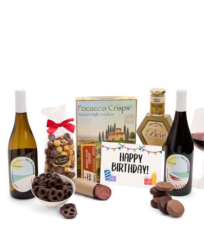 A gift set featuring two bottles of Hill & Harbor wine - white and red, focaccia crisps, two cheeses, mustard, summer sausage, caramel popcorn, chocolate pretzels, six chocolate-covered Oreos and a Birthday card to complete the gourmet experience.